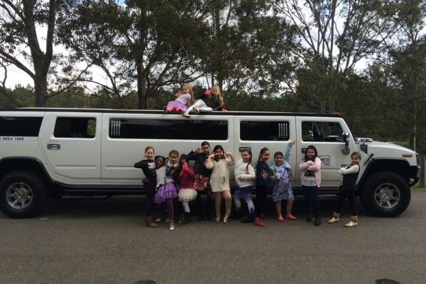 Posing for photo on top of Stretch Hummer